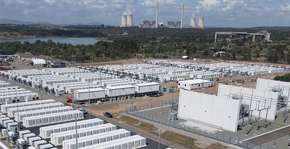 AGL’s Liddell Battery achieves full commercial operation Battery units at Liddell BESS with power station infrastructure in the background