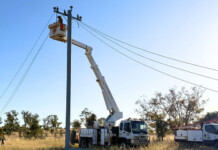 From trial to strategy: The case for composite utility poles Linemen working on the Roma to Injune line with a crane truck