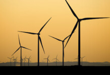 Why are new wind farms stuck in the doldrums in Australia? Large wind farm with orange coloured sky in the background