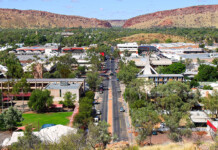 Power restored to thousands in Alice Springs after storm Aerial view of main street in Alice Springs with mountains in background