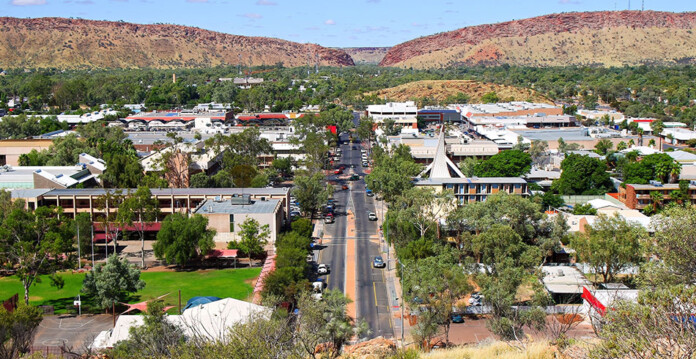 Aerial view of main street in Alice Springs with mountains in background