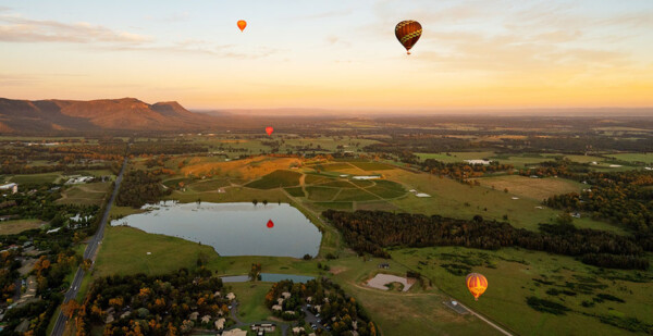 Hot air balloons at sunset over picturesque Hunter Valley landscape