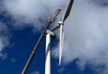 Huxley Hill Wind Farm gets new lease of life Large Vestas wind turbine being upgraded with large crane beside it and cloudy blue sky overhead