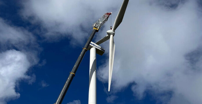 huxley-hill-wind-farm-1 Large Vestas wind turbine being upgraded with large crane beside it and cloudy blue sky overhead