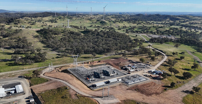 Aerial photo of the Uungula Wind Farm substation with wind turbines on the horizon